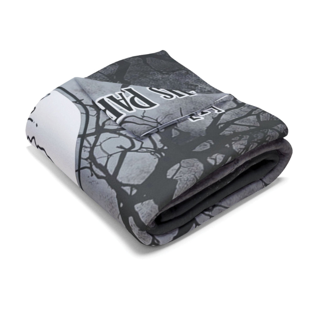 A folded fleece blanket featuring a spooky tree branch pattern in black and gray over a white background, with the words 'IT'S DARK' printed in a stylized font.