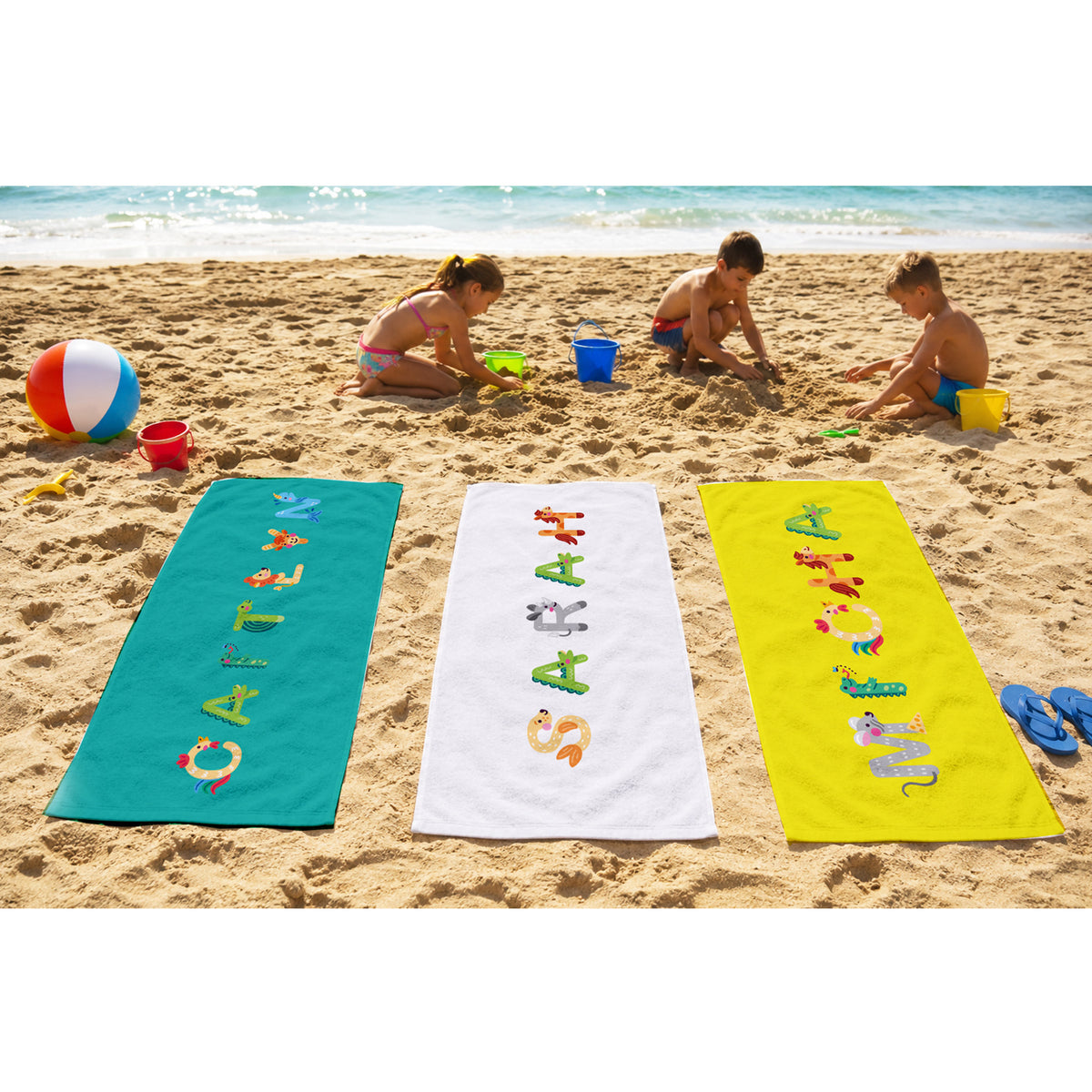 Pink towel with name willa spelled out in animal letters