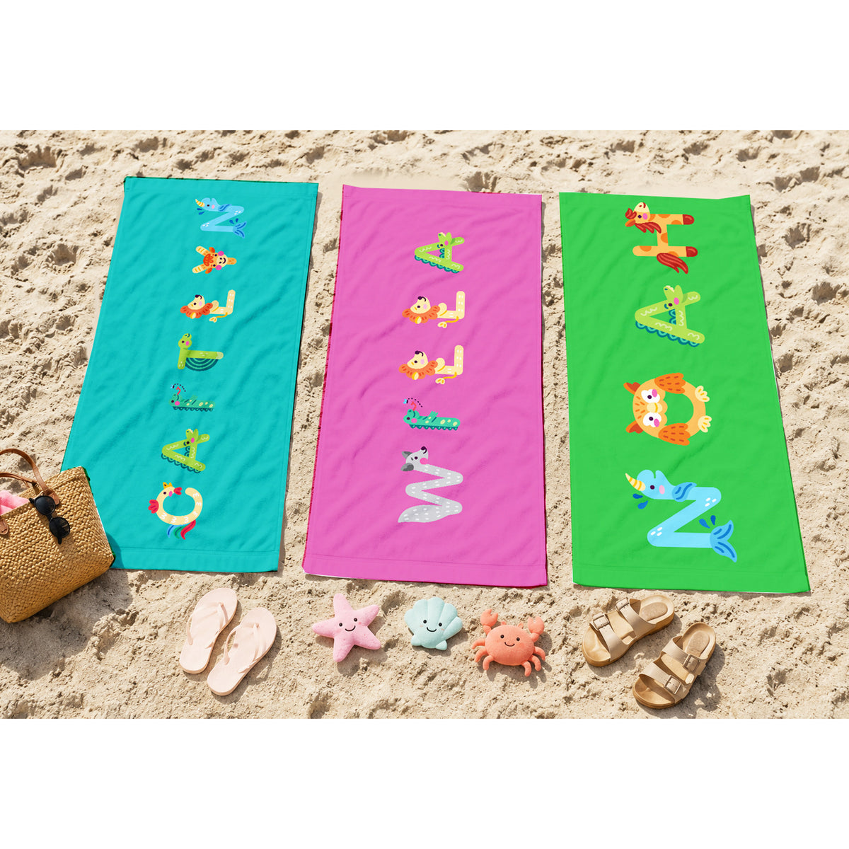 Pink towel with name willa spelled out in animal letters