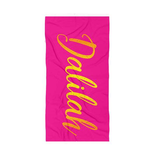 Pink beach towel with name Dalilah with gold serif lettering with a slight gradient