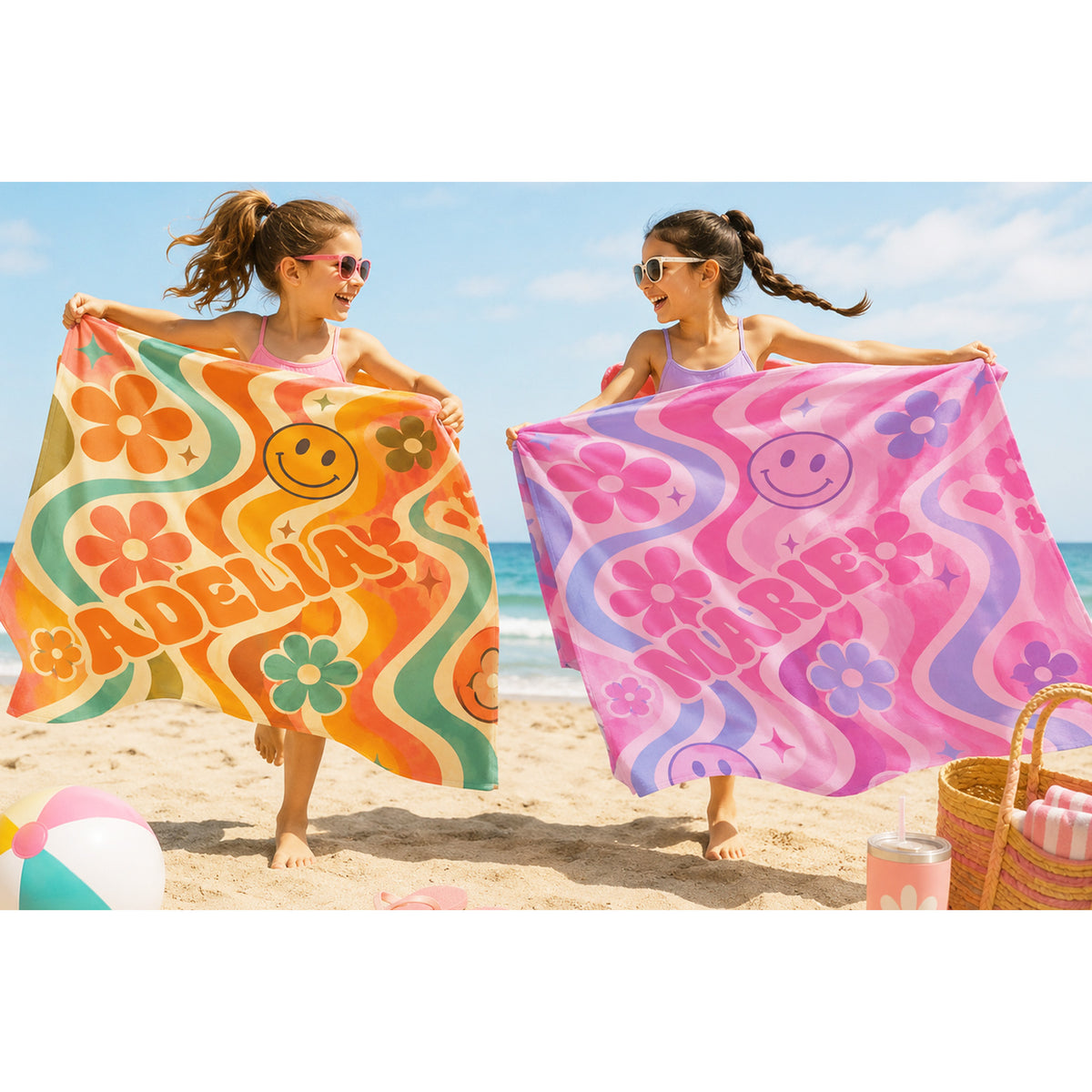 Colorful PInk beach towel with pink smily faces, pink and blue flowers on light pink background