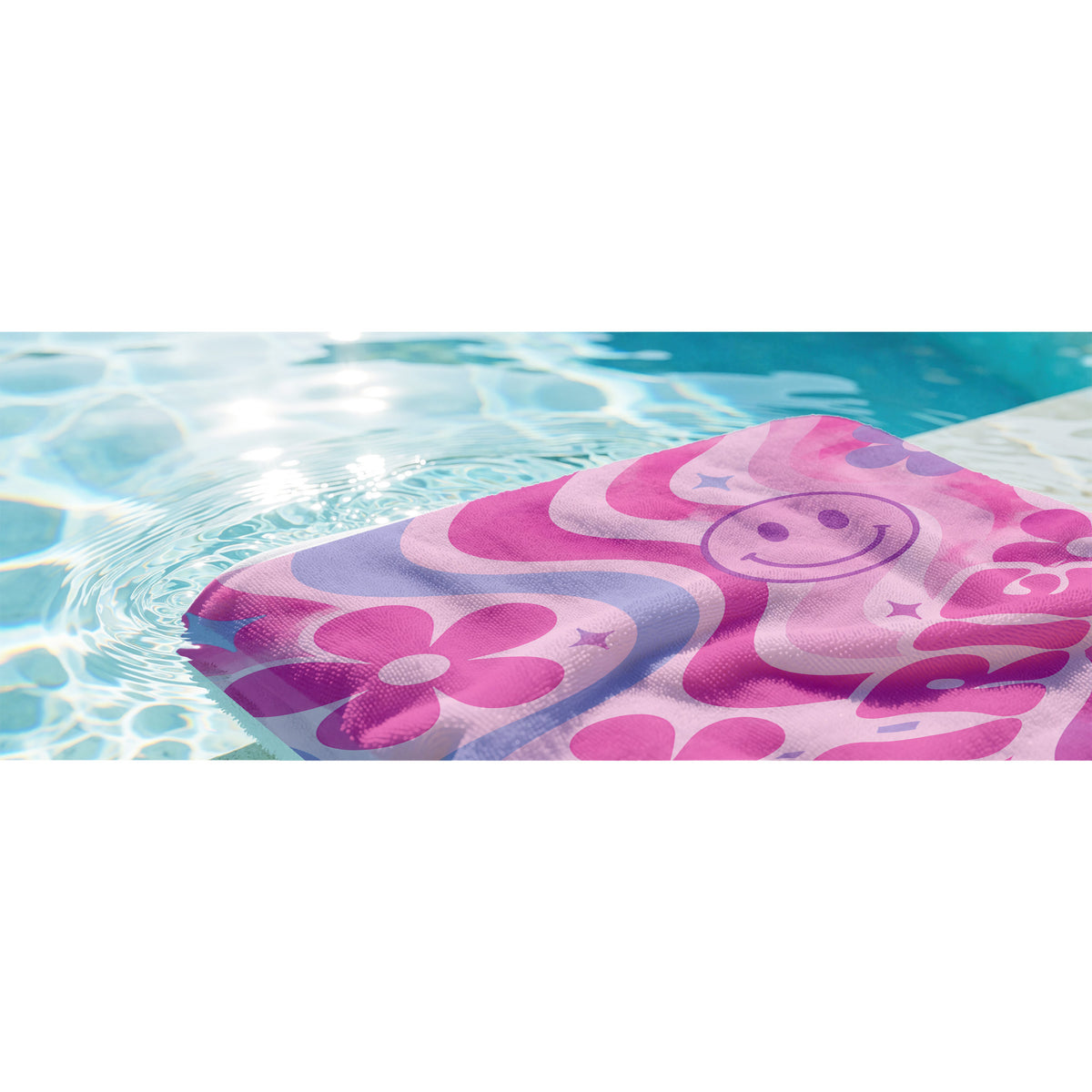 Colorful PInk beach towel with pink smily faces, pink and blue flowers on light pink background