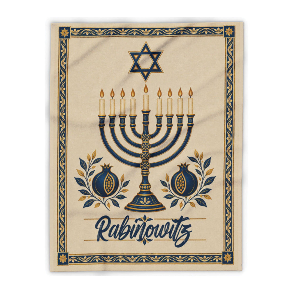 A square beige textile print or blanket featuring a decorative Hanukkah design with a menorah, Star of David, pomegranates, and the word 'Rabinowitz' in script, shown on a white background.