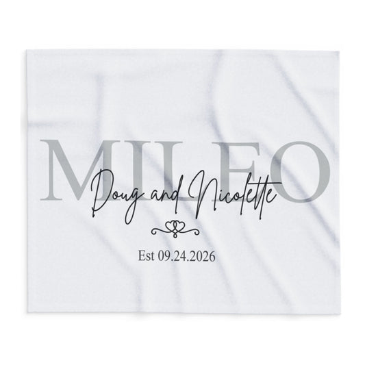A square white marble-patterned wedding favor card featuring personalized text. The card displays the name 'MILEO' in a large, semi-transparent gray serif font, with 'Doug and Nicolette' written in black cursive script in the center.