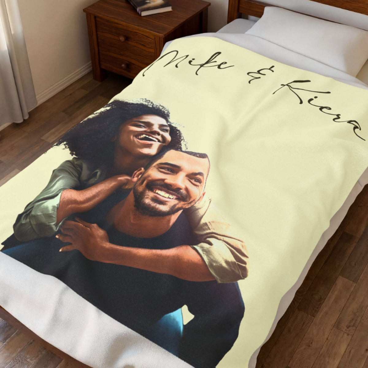 A personalized bedding set featuring a custom photo print of a smiling couple on a cream-colored blanket, styled on a bed in a bedroom setting.
