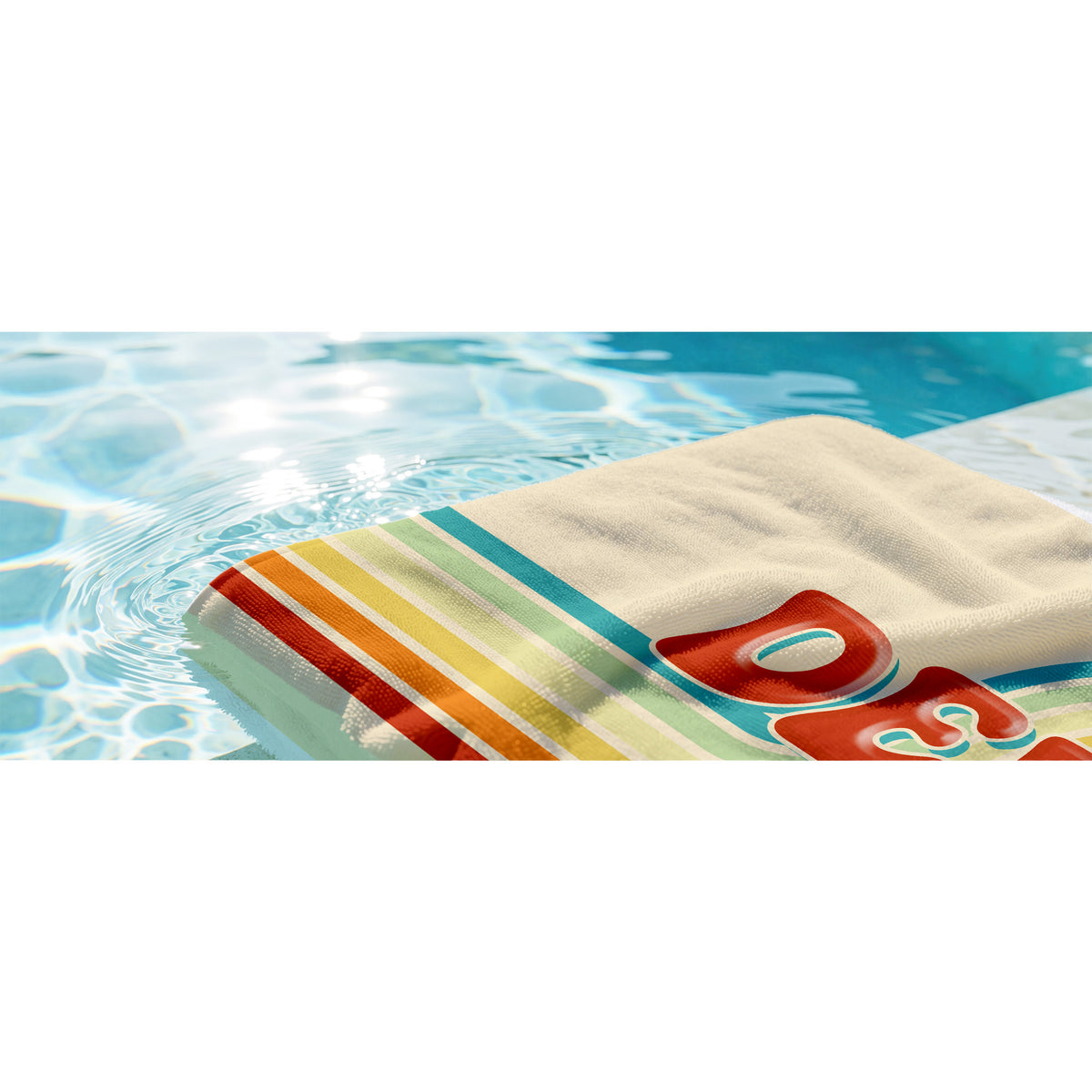 A close-up of a folded beach towel with a retro striped pattern in orange, yellow, green, and white, featuring a large red and white 'COZY' logo, partially submerged in clear blue swimming pool water.
