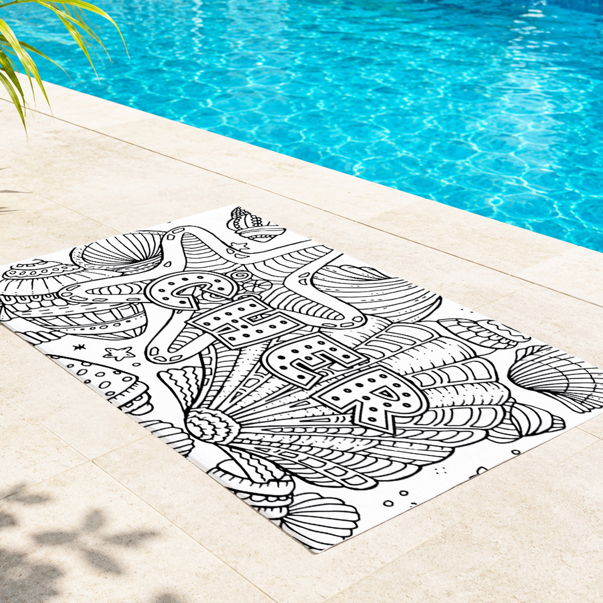 May include: A white rectangular beach towel featuring a black line art design of various seashells and the word BEACH printed in large block letters. The towel is scattered with several colorful markers used for coloring the printed illustrations.