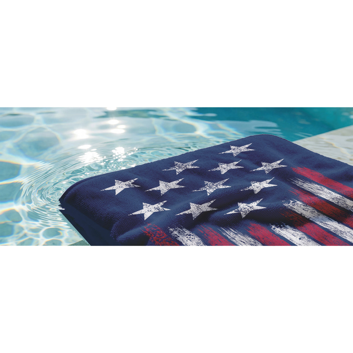 end of blue towel with white stars and red and white stripes in water