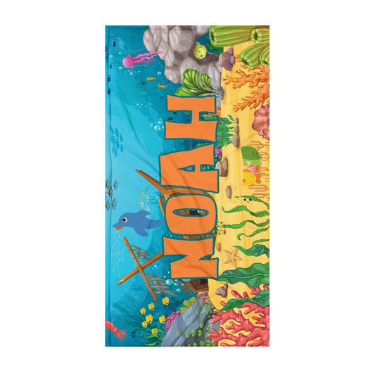Kids beach towel with sunken treasure scene with bright colors and coral with name Noah.