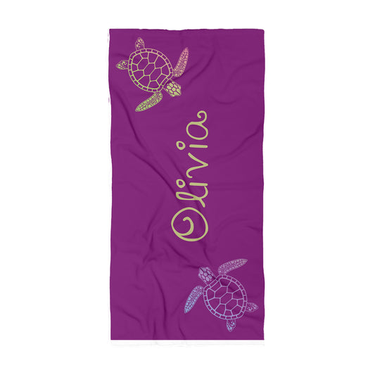 Purple towel with irridescent turtles in each corner with name Olivia in the middle in gold.