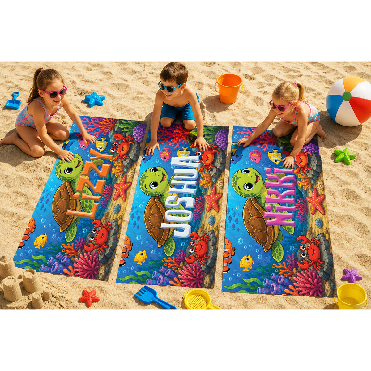 Three children play on a sandy beach with three personalized underwater-themed pool floats spelling 'Joshua', 'Mia', and 'Nora'. The colorful floats feature cartoon sea turtles, crabs, and corals on a blue ocean background, surrounded by beach toys like a beach ball, buckets, and star-shaped toys.