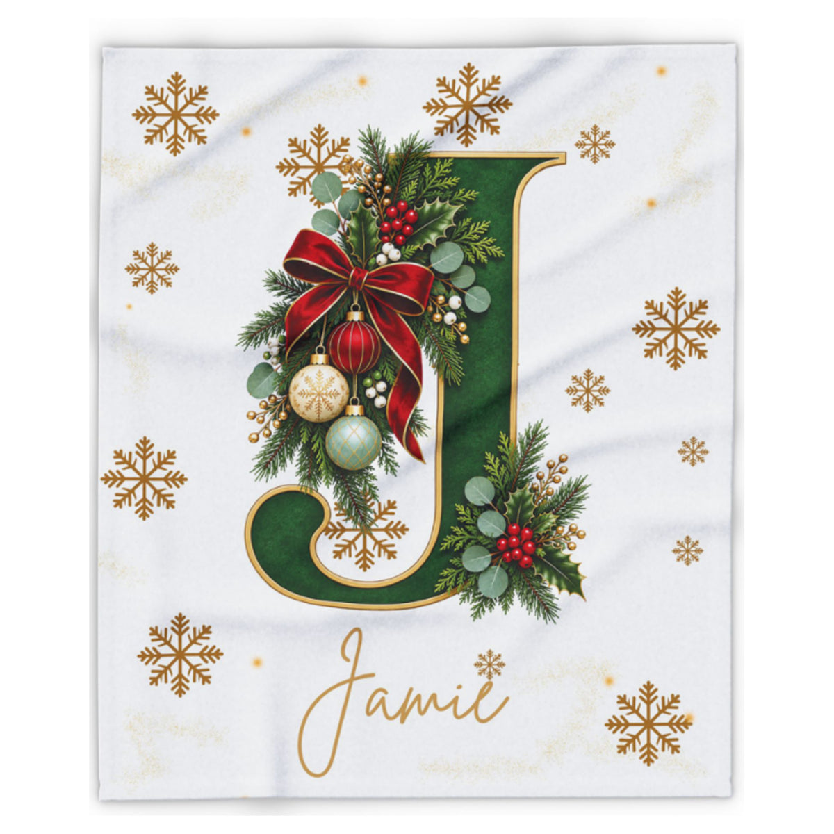 A personalized Christmas-themed blanket featuring a large green letter 'J' decorated with a red bow, green pine branches, red berries, and gold ornaments, with the name 'Jamie' written in gold cursive below. The blanket has a white background decorated with gold snowflakes.